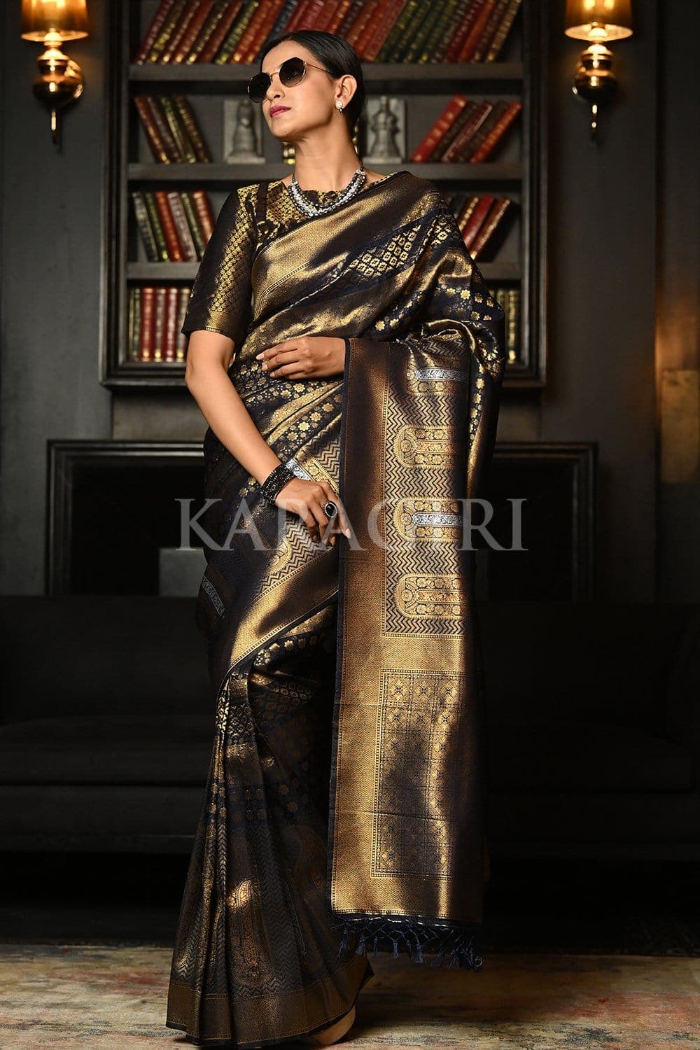 In a gorgeous black color pattu / kanjeevaram saree with butti, red color  elbow length s… | Saree wearing styles, Indian saree blouses designs, Saree  blouse designs