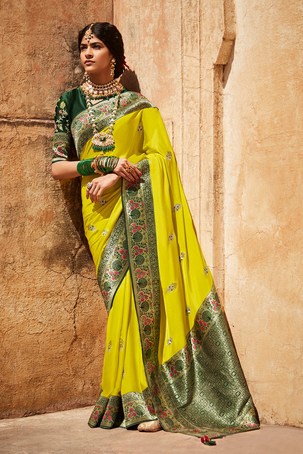 Yellow pure silk saree with green patterns blouse and border (Unstitched)